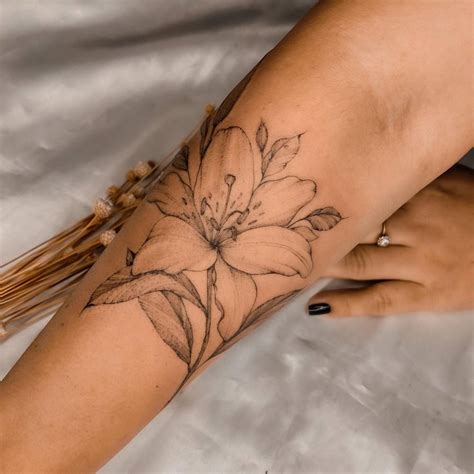 lily flower tattoo  onm  forearm illustrative