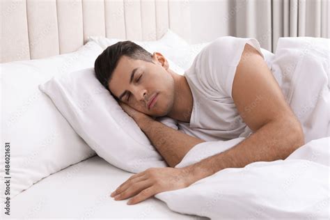 Handsome man sleeping in bed at home Stock Photo | Adobe Stock