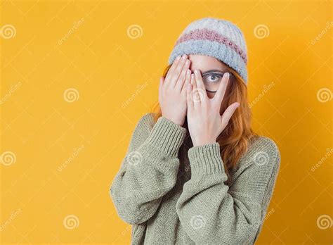 peaking obscured face close  young woman covering face  hands