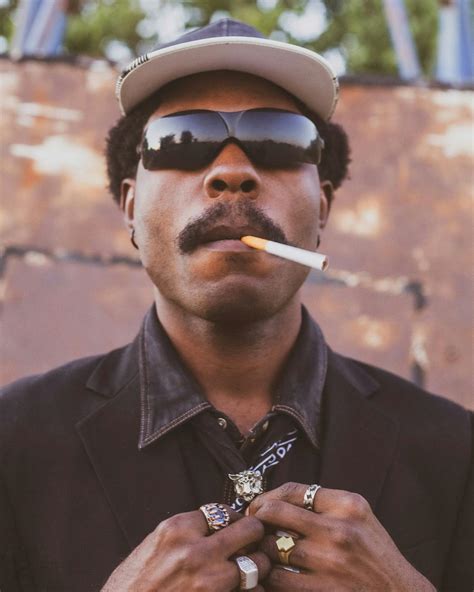 confident man  sunglasses smoking outdoors  stock photo