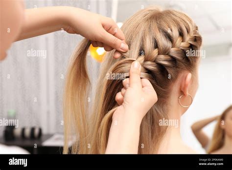 professional stylist braiding clients hair  salon stock photo alamy