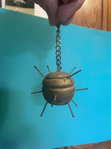 Weird brass colored spiky ball thing with a chain, around 1-2 oz in
