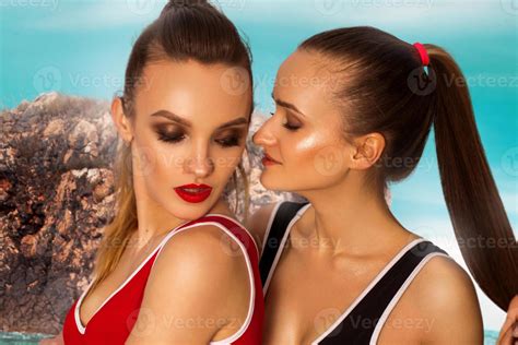 two hot girls posing on the beach 16036987 Stock Photo at Vecteezy