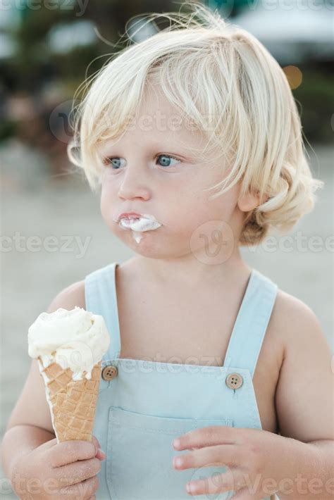 cute boy  melted ice cream cone  street  stock photo
