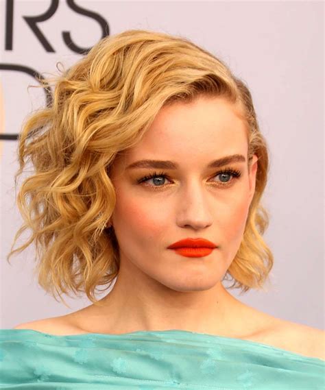 Julia Garner Medium Wavy Dark Blonde Bob Haircut with Side Swept Bangs