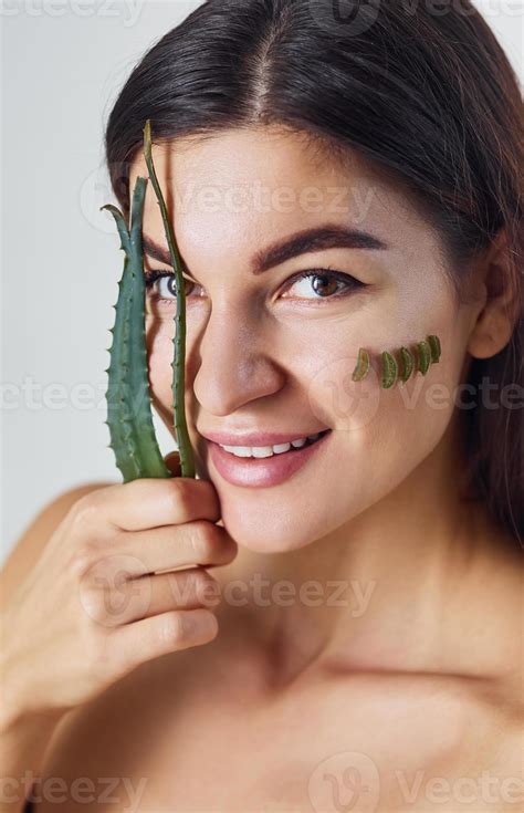 A woman is in the studio against white background with aloe vera