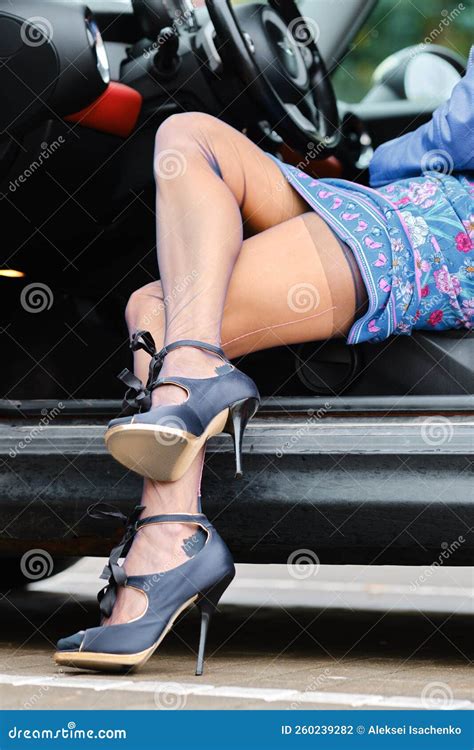 Crossed Female Legs in Stockings with Garter Belt in the Car Stock
