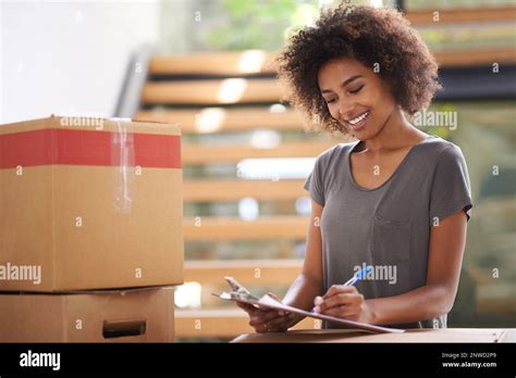 Heres to a new start. Shot of a young woman moving into her new house ...