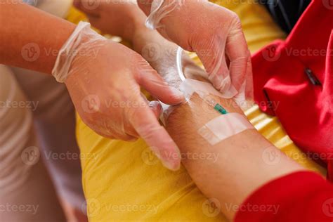 Healthcare Professional Inserting IV in Patient's Arm 50484190 Stock