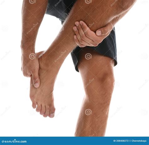 Man Suffering from Foot Pain on White Background, Closeup Stock Photo