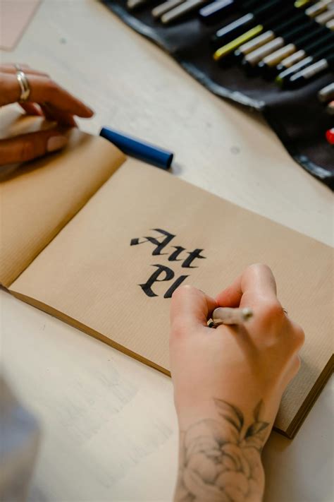person writing  brown paper  stock photo