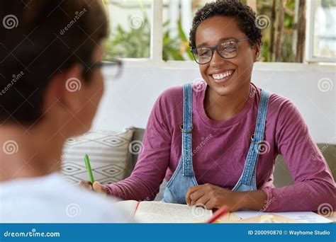 positive young black female journalist  spectacles takes interview
