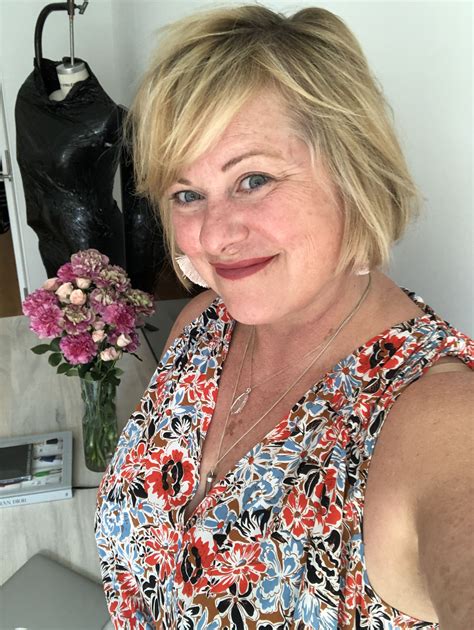 a woman with blonde hair standing in front of a mannequin