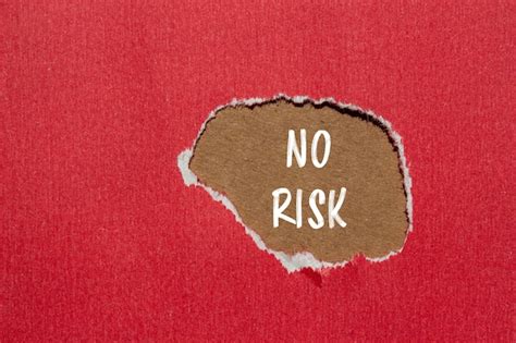 premium photo  risk written  ripped red paper  brown