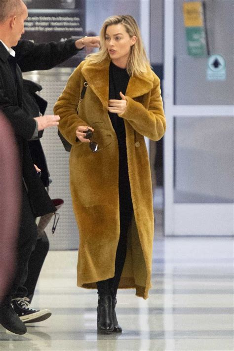 Margot Robbie in a Long Yellow Fur Coat Arrives at the JFK Airport in New York City 12/02/2018-5 ...