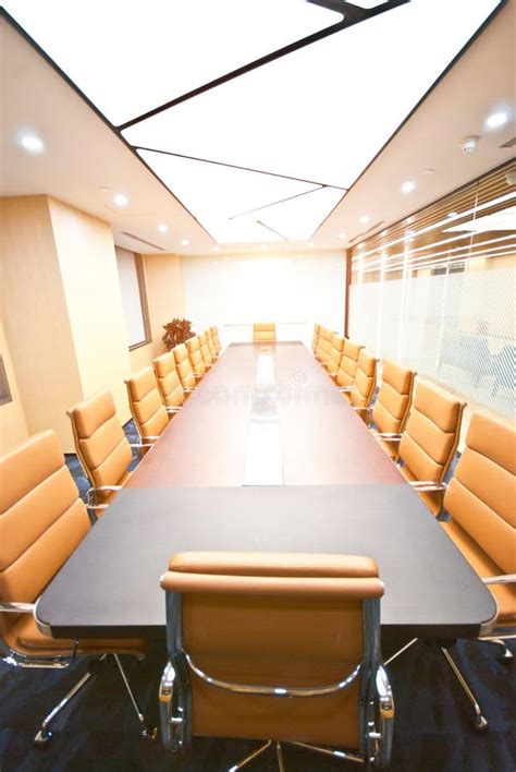 Modern Conference Room with a Large Wooden Table and Numerous Chairs ...