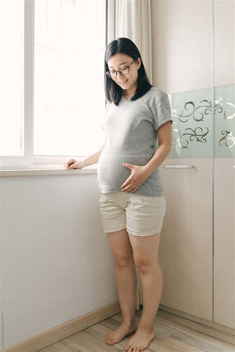 "Portrait Of Chinese Pregnant Woman" by Stocksy Contributor "MaaHoo