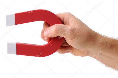 Hand holding magnet Stock Photo by ©hyrons 38121789