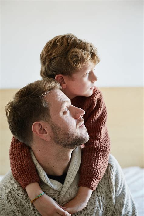"Dad And Son In A Relax And Love Moment In The Bedroom At Home" by