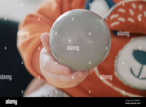 Baby holding ball hi-res stock photography and images - Alamy