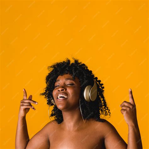Free Photo | Naked black young female singing in headset in studio