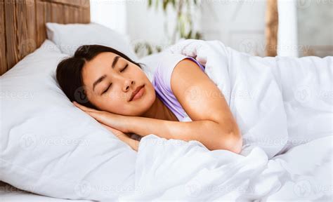 Sweet Dreams. Asian Girl Sleeping Well Lying In Cozy Bed In Bedroom
