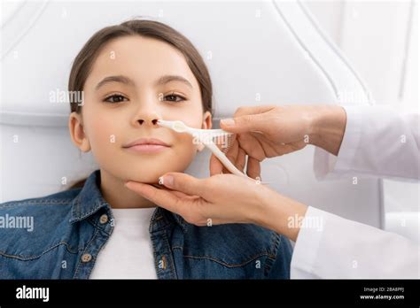 cropped view  otolaryngologist examining nose  kid  nasal