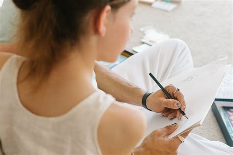 person  drawing   white paper  stock photo