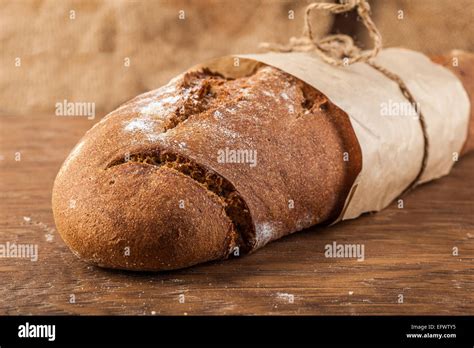 bread wrapped  paper   wooden background stock photo alamy