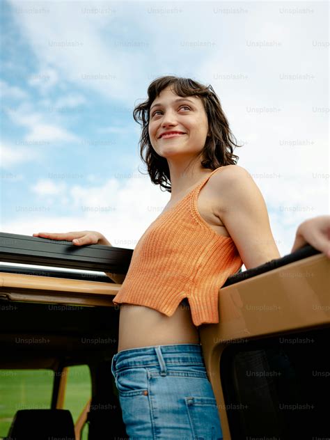 A woman standing in the back of a pick up truck photo – Girl Image on