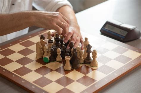 close   hands  middle aged caucasian man playing chess stock