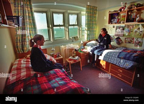 Two Roedean schoolgirl pupils chat in their boarding school dormitory ...