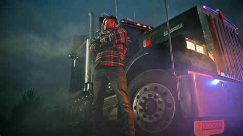 Interstate 80 Truck Stop. Caucasian Truck Driver Staying in Front of
