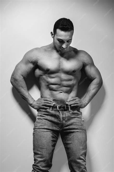Premium Photo | A young athlete bodybuilder poses in the studio topless