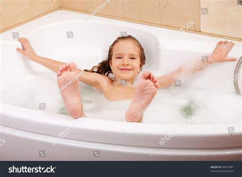 Child In The Bathtub. Girl Washes In The Bathroom Stock Photo 94971847
