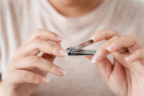 Woman cutting fingernails using nail clipper, Healthcare, Beauty