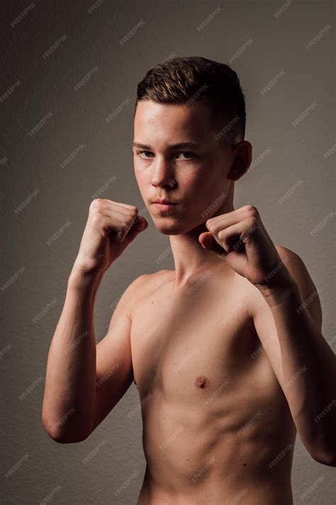 Premium Photo | A teenage boxer athlete is training to box on dark ...