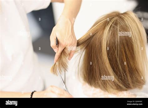 Woman hairdresser cuts hair with scissors in barbershop Stock Photo - Alamy