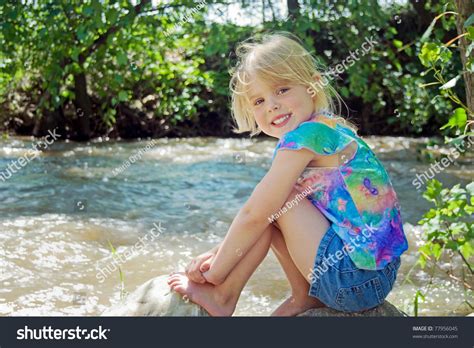 Little Girl Sitting On River Rock Stock Photo 77956045 - Shutterstock