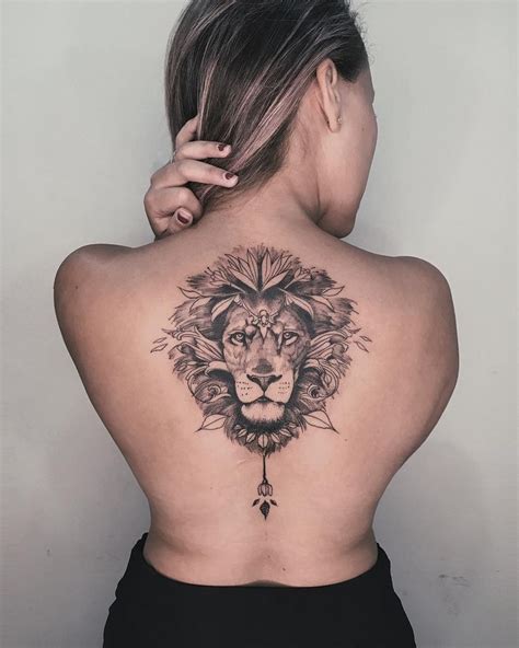 a woman with a lion tattoo on her back