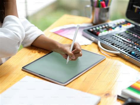 Closeup, graphic designer using stylus pen sketching new prototype on