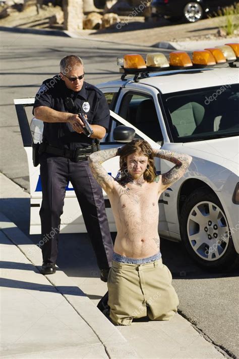 police officer arresting young man stock photo image