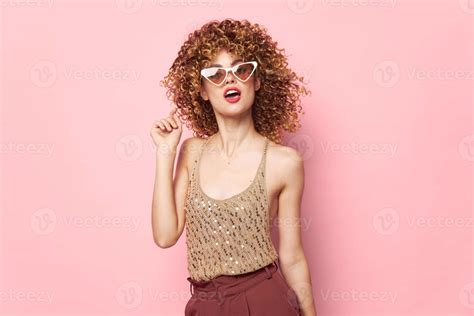 Pretty woman Lips dark glasses curly hair studio pink background