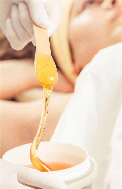 Premium Photo | Sugaring armpit wax in a professional cosmetologist
