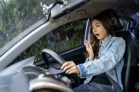 Asian woman shocked and shouting while driving on the road She was