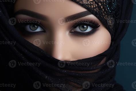 Portrait of beautiful Arab woman with blue eyes wearing black scarf