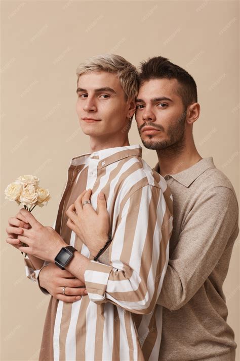 Premium Photo | Minimal waist up portrait of young gay couple embracing