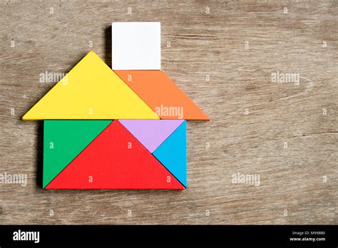 color tangram puzzle  house shape  wood background stock photo alamy