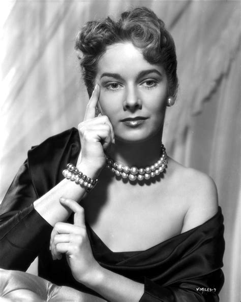 Vera Miles photographed waering a silk black, off-the-shoulder, boat
