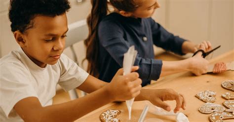 Two Kids Putting Cream on Cookies · Free Stock Photo